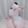 A woman models the miracle nikki cosplay maid dress, featuring a sweet lolita style with pink ruffles, bows, and a frilly apr...