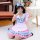 A girl wearing a pink and blue maid outfit with ruffles, holding a phone to take a mirror selfie indoors near a piano and tab...