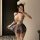Woman in mist temptation lingerie set – sheer mesh sleepwear with cat ears, posing seductively in a dimly lit room.