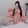 A person wearing a pink misty romance kimono lingerie set with floral patterns, posing while taking a selfie. the outfit feat...