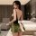 A woman models the muoqing vintage deep v velvet sleep dress, featuring a lace design and a bow detail, perfect for festive a...