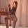 Woman wearing mystique leopard lace bodysuit, a seductive backless mesh lingerie with sheer stockings, posing elegantly in a ...