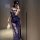 Woman in navy lace cami set with high slit, holding feather accessory; modest yet alluring sleepwear by naben.
