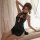 A woman poses elegantly in a black high-neck lace print lingerie set, featuring a vintage-inspired sheer cheongsam sleep dres...