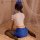A woman sits on a bed wearing a sailor-themed novelty lingerie set, featuring a white crop top with blue accents and matching...