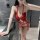 Woman wearing red lace night desire plus size bodysuit with open-crotch design, adjustable ties, and elegant sleepwear stylin...