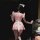 A woman models a charming pink maid costume with ruffled sleeves and skirt, perfect for anime cosplay events. ideal for lolit...