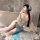 A woman poses in a bathroom, wearing a night silk hanfu lingerie set featuring a seductive cross-slit bodice and halter neck ...
