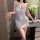 A woman poses elegantly in a white night silk lace sheer sexy sleepwear set, featuring a backless cami dress with push-up bra...