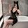 Woman in black lace sleep dress set taking mirror selfie, sheer sexy lingerie with cat ears headband.