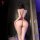 A woman stands with her back to the camera, wearing a red night silk lingerie set inspired by ancient chinese hanfu style. th...