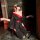 A woman poses elegantly in a black and red night silk sensual hanfu lingerie, featuring intricate floral patterns and a flowi...
