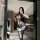 Woman modeling night silk sensual lace bodysuit, sheer mesh open-crotch thong bodystocking with straps and stockings in moder...