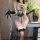 Woman wearing night silk sensual lace bodysuit with backless cutout, adjustable straps, and sheer gloves.