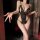 Woman in black lace open-crotch bodysuit with matching thong, holding wine glass — night-silk sensual sleepwear set.