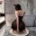 A woman poses in a luxurious bathroom wearing a black night silk sensual lace sheer dress, featuring a wire-free design and i...
