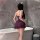 A woman stands by a bathtub wearing a purple night silk dress with lace detailing, featuring a sheer design and bodycon fit.