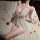 Woman wearing white butterfly-bow lace sleep dress on plush rug with rose petals. night-silk sensual lace sleep dress – pure ...