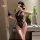 A woman poses with a smartphone, wearing a black lace night silk sexy lingerie set featuring vintage red qipao style design e...