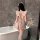 A woman stands by a bathtub wearing a pink night silk sexy maid costume, featuring ruffled details and a sweet servant style ...