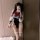 A person poses with a smartphone, wearing a night-suit set featuring a sailor uniform design. the outfit includes a white blo...