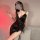 Seductive black satin nightgown with tie-strap design, v-neckline, and irregular hem, perfect for alluring allure.