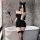 Woman in black lace back sleepwear set with cat ears, posing seductively by bathtub — perfect for romantic nights.