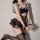 Sexy black cat-ear maid costume with open-crotch design, featuring lace details and stockings for seductive allure.