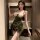 A woman poses in a nightgown featuring french-style lace and velvet, perfect for romantic new year celebrations.