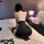 Woman in black nightsese sexy mesh halter bodycon mini dress with lace-up back, kneeling on bed surrounded by rose petals and...