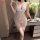Woman wearing white lace babydoll sleepwear with adjustable straps, sheer mesh design, and floral pattern.