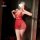Woman wearing red lace babydoll dress with tassels and adjustable straps, posing in mirror selfie for date night.