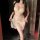 Woman wearing peach lace babydoll dress with adjustable drawstring, sheer ultra-thin sleepwear for small bust.