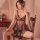Woman wearing black sheer mesh nightsigh nightseduce lingerie set with lace trim, sitting on wooden chair for romantic date n...