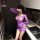 Woman modeling purple sheer lace bodysuit with open-crotch design, featuring transparent mesh panels and long sleeves in mode...