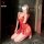 Woman kneeling in red lace tie-up sleep dress with deep v and tassels, part of nightsigh nightseduction sexy lingerie collect...