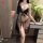 Woman wearing nightsigh sexy lace sleepwear set – sheer mesh cami and briefs with bow, holding wine glass.