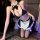 Woman kneeling in black and white nightsigh sexy maid costume with ruffled apron, choker, and sheer stockings.