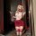 Woman in red nightsigh nightsere sexy lingerie dress with white top, posing with phone and champagne glass.
