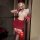 Woman wearing red nightsigh nightsere sexy lingerie dress, a high-slit strapless bodycon mini dress with lace stockings and g...
