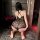 Woman kneeling in black lace nightsigh bodysuit with sheer backless halter design, elegant lingerie set.