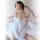 Woman wearing white sheer off-shoulder nightgown on bed — nightsigh sexy sheer lingerie set, snowflake-style chemise for wome...