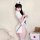 Woman in white nurse costume lingerie set with cut-out bust, holding giant syringe prop for role play.