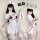 Woman modeling white nurse costume lingerie set with cut-out bust, holding oversized syringe prop for seductive role play.