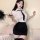 A woman poses wearing a white blouse with a black tie, paired with a black pencil skirt and lace stockings, embodying an air ...
