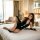 A woman poses on a bed wearing an elegant black oushilin seductive backless high-slit qipao lingerie set, perfect for vintage...