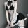 Black and white maid-themed lingerie set featuring a halter top with ruffles, matching skirt, stockings, and garters, perfect...