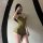 Woman wearing green peachy lace halter deep v sheer lingerie set - sensual cross-back erotic bodysuit for women, posing in fr...