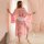 A woman stands gracefully wearing a pink cherry blossom kimono robe, featuring sheer satin lace details. the elegant design e...