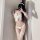 Woman wearing white fuzzy lingerie set with bow detail, garter belt, and fishnet stockings for cosplay or halloween.